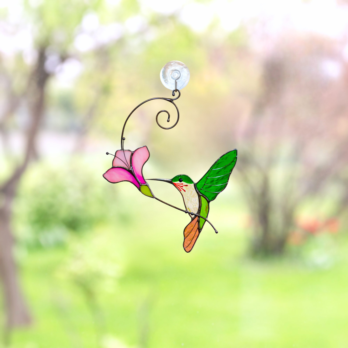 Handmade hummingbird suncatcher on the window