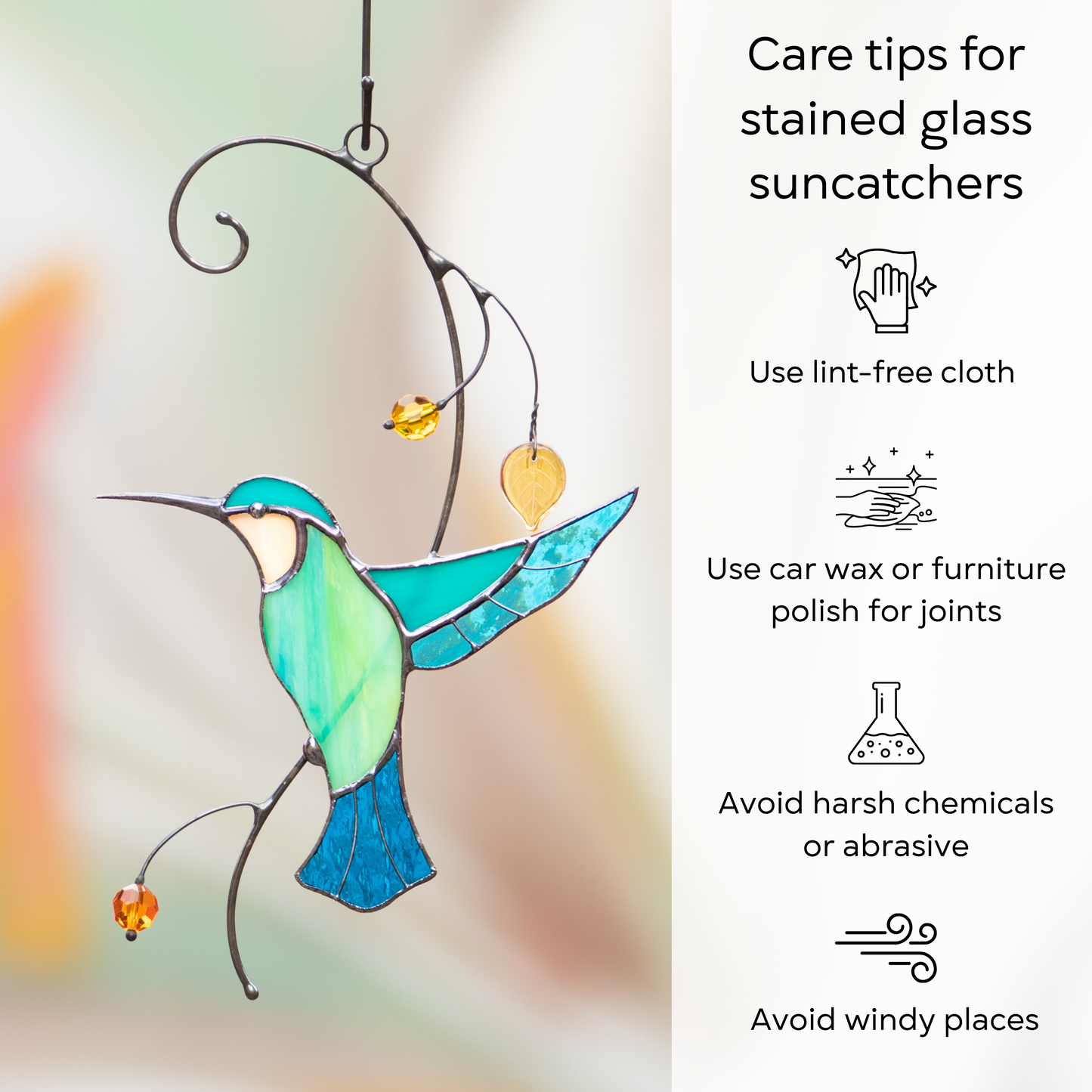 A stained glass hummingbird in turquoise shades with hanging beads and leaves, displayed with care instructions on the side