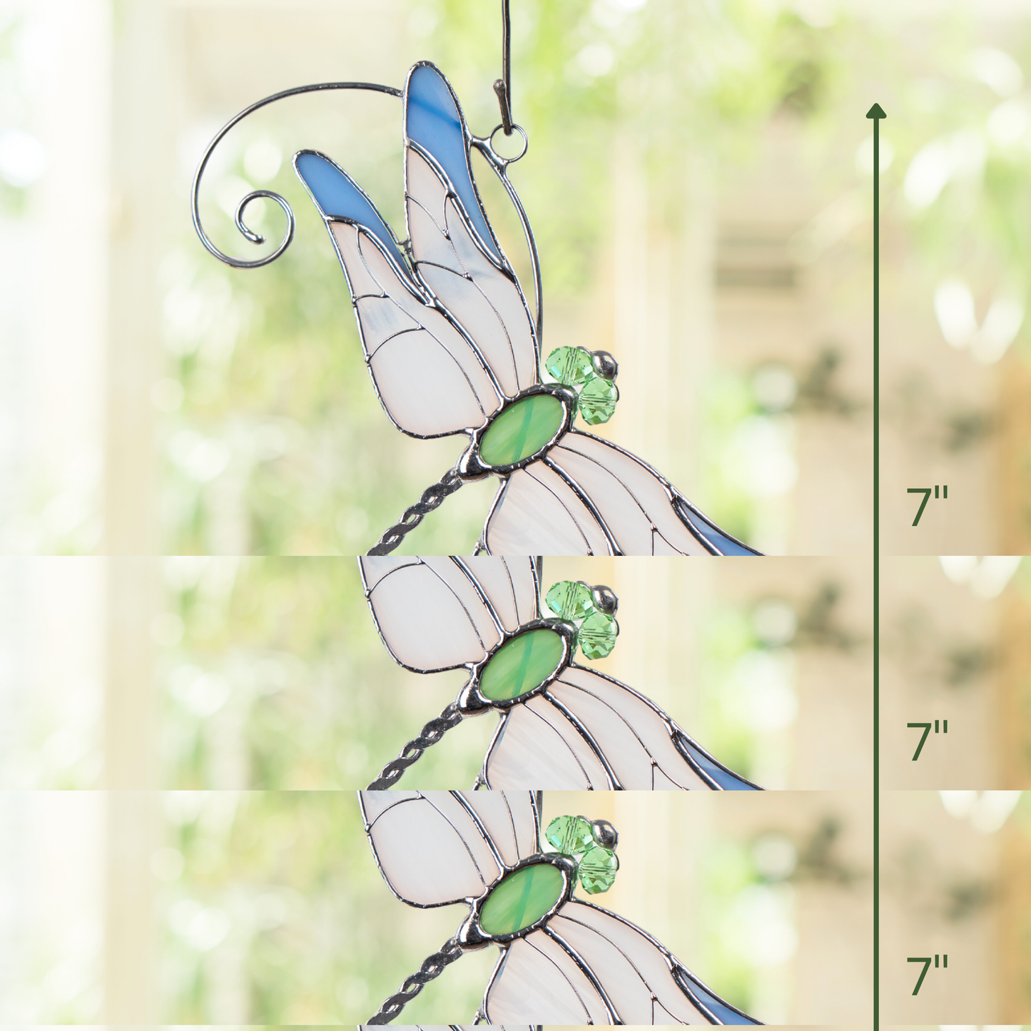 Stained glass dragonfly suncatcher hanging indoors with size indicator showing 7 inches tall.
