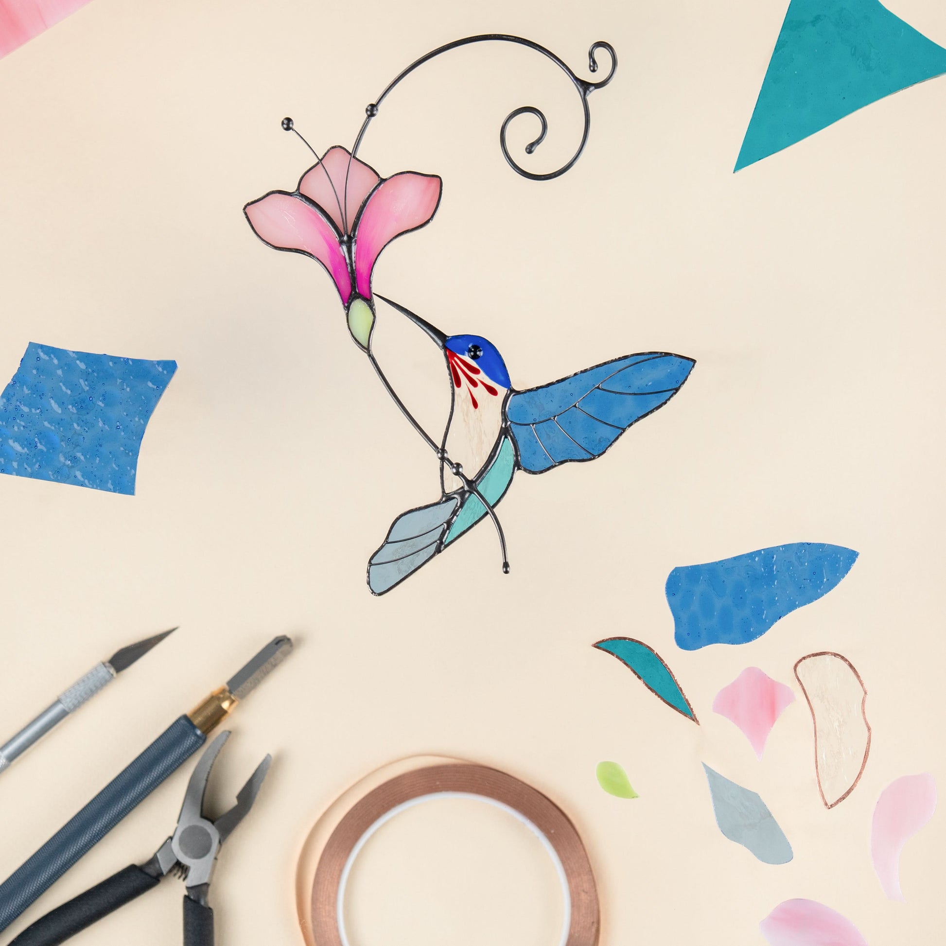 Stained glass hummingbird in blue with it`s details