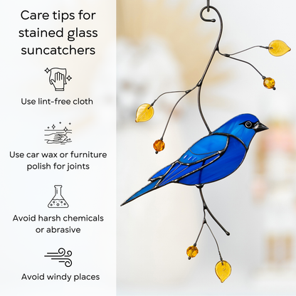 Infographic with care instructions for stained glass suncatcher featuring indigo bunting bird, focusing on gentle cleaning and protection.