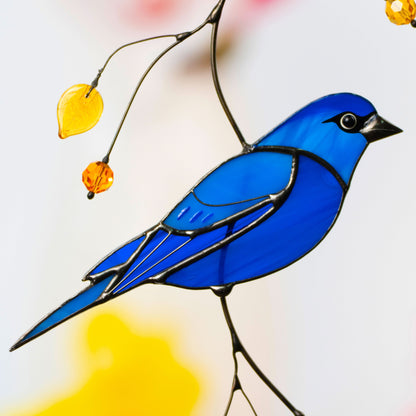 Detailed view of indigo bunting stained glass suncatcher with yellow beads, symbolizing joy and color in daily life.