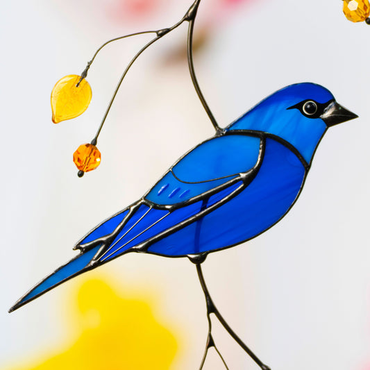 Detailed view of indigo bunting stained glass suncatcher with yellow beads, symbolizing joy and color in daily life.