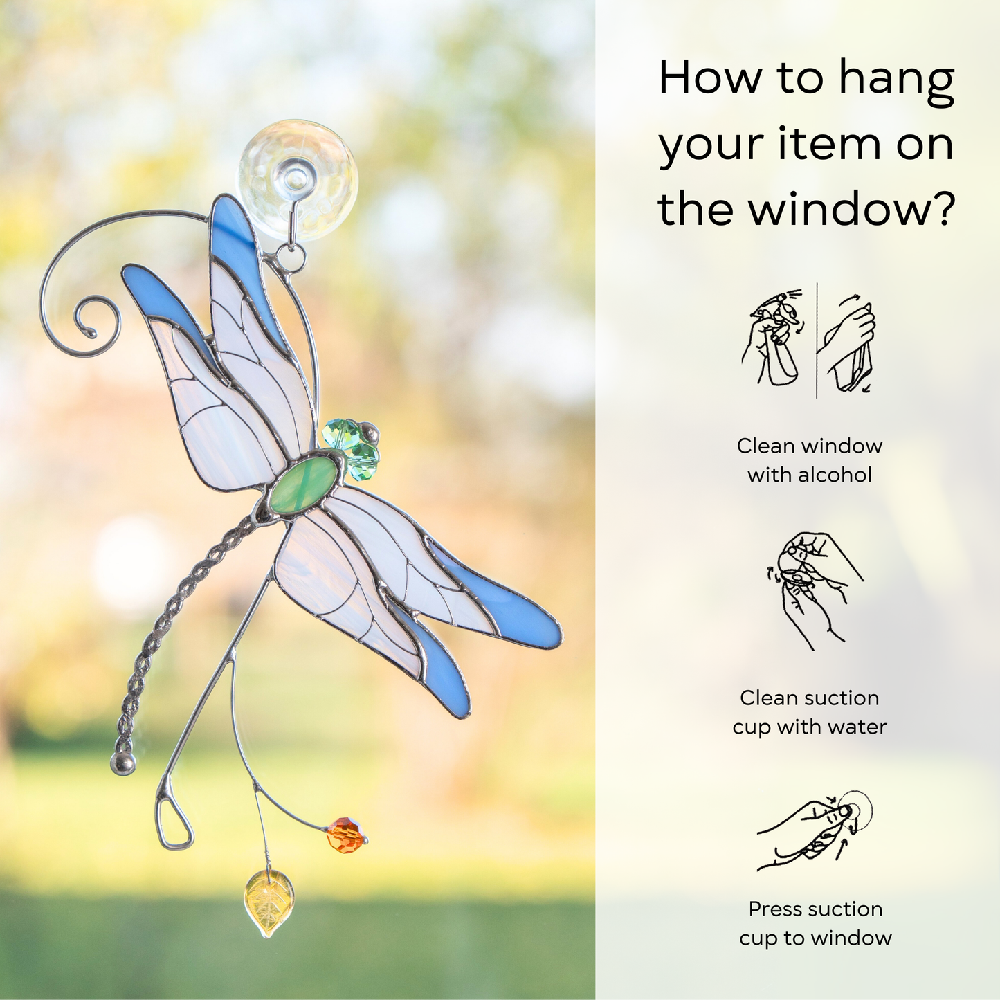 Blue stained glass dragonfly hanging from a suction cup on the window, with illustrated hanging instructions: clean window and suction cup, press a cup to the surface.