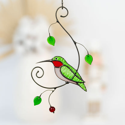 Green hummingbird suncatcher with red throat and green leaves.