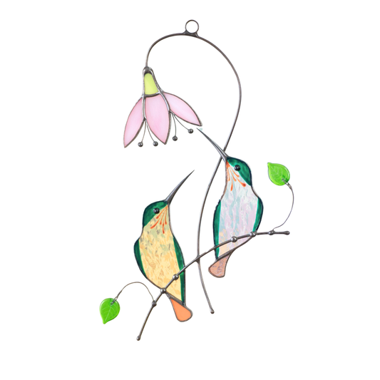Stained glass couple of green hummingbirds sitting on the branch with pink flower.