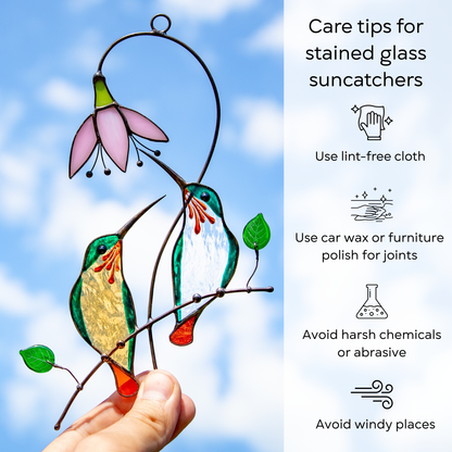 Suncatcher pair of green hummingbirds with sky on the background and care tips beside: use lint-free cloth, polish joints with car wax or furniture polish, avoid harsh chemicals, and windy places.