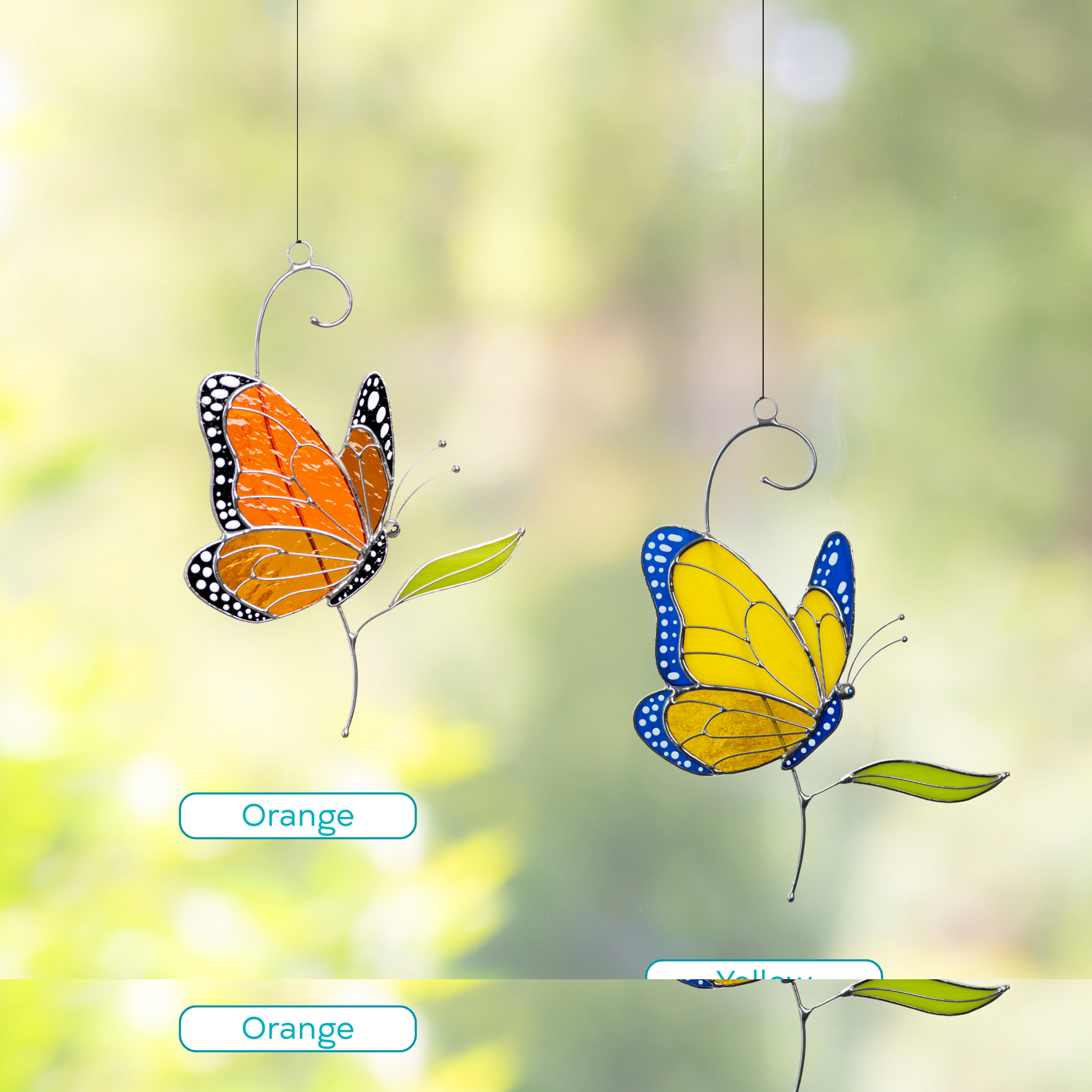 Stained glass monarch butterflies in orange and ukrainian colors hanging in a blooming garden with vibrant background.