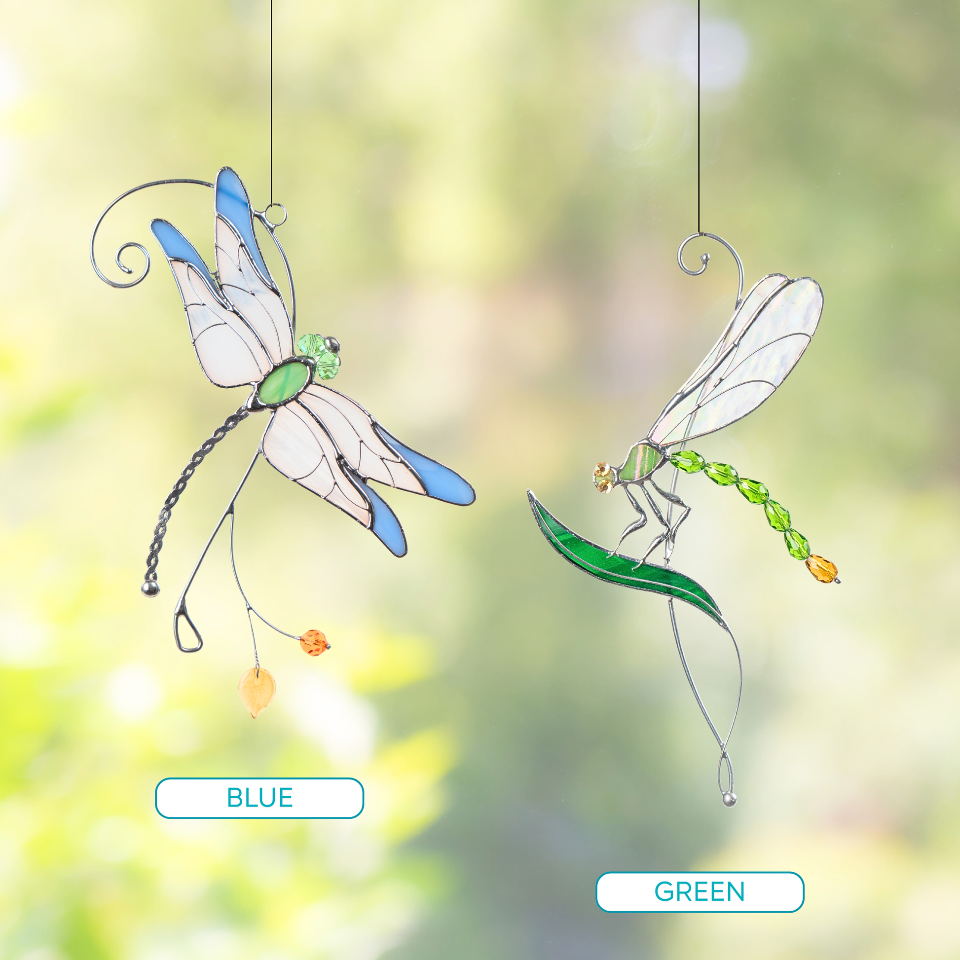 Pair_of_stained_glass_dragonflies_suncatchers_in_green_and_blue_color_options_shown_in_outdoor_setting
