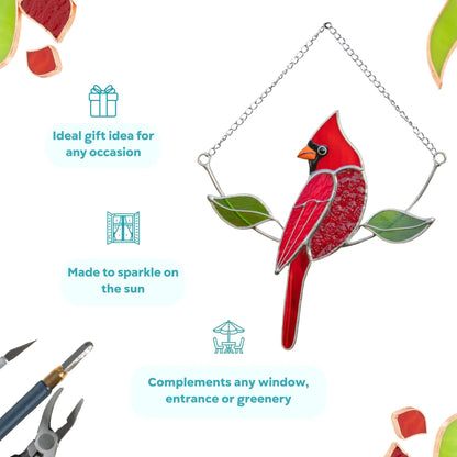 Red stained glass cardinal hanging on a chain, shown with decorative labels and tools. Suncatcher is an ideal gift for any occasion