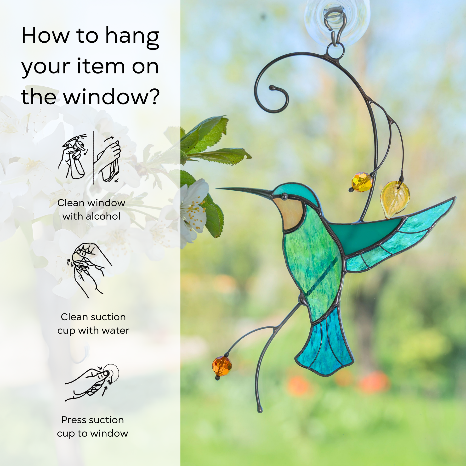 A delicate glass hummingbird yellow beads hanging in a window with greenery in the background