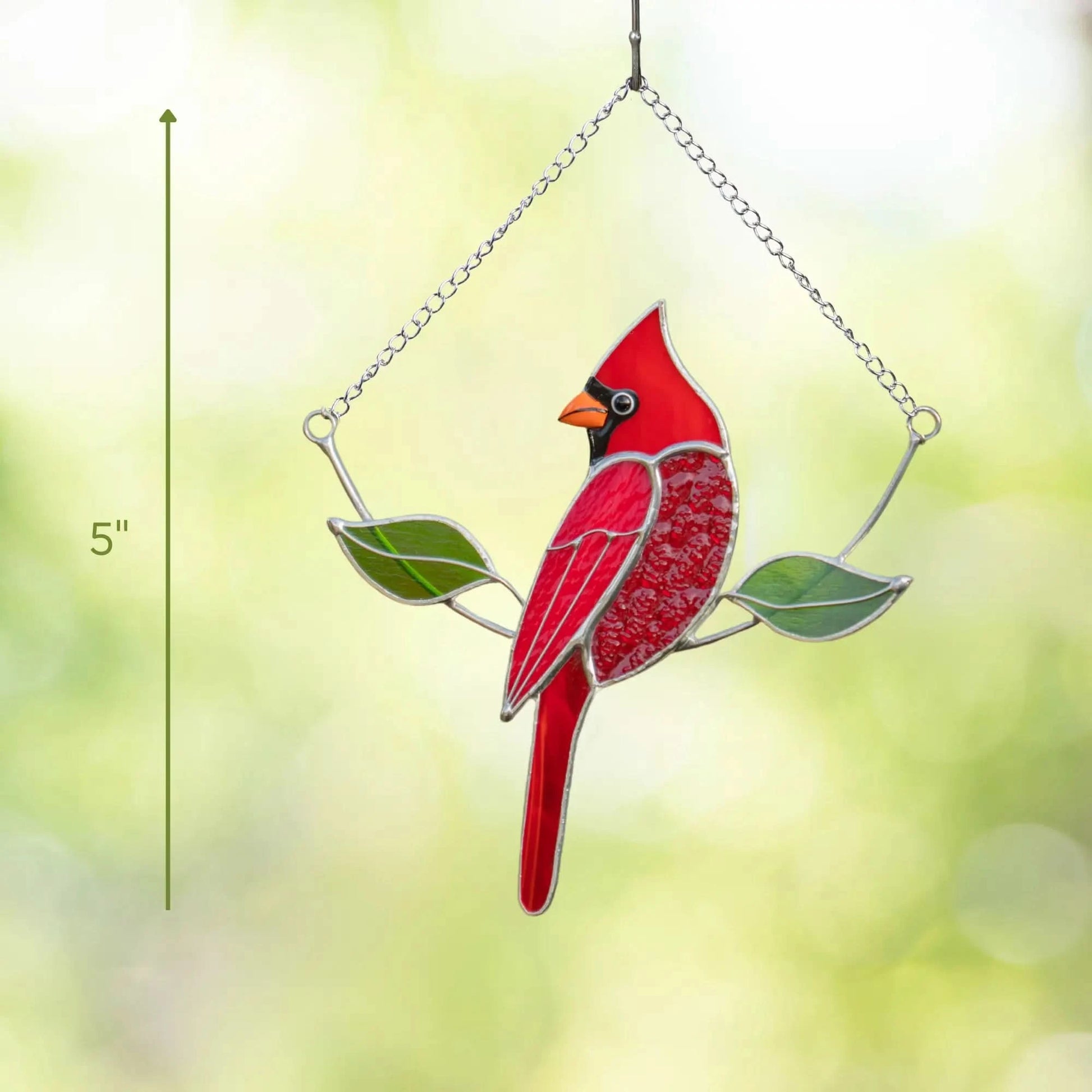Stained glass red cardinal bird on a branch with height measurements at 5 inches, against a blurred green background