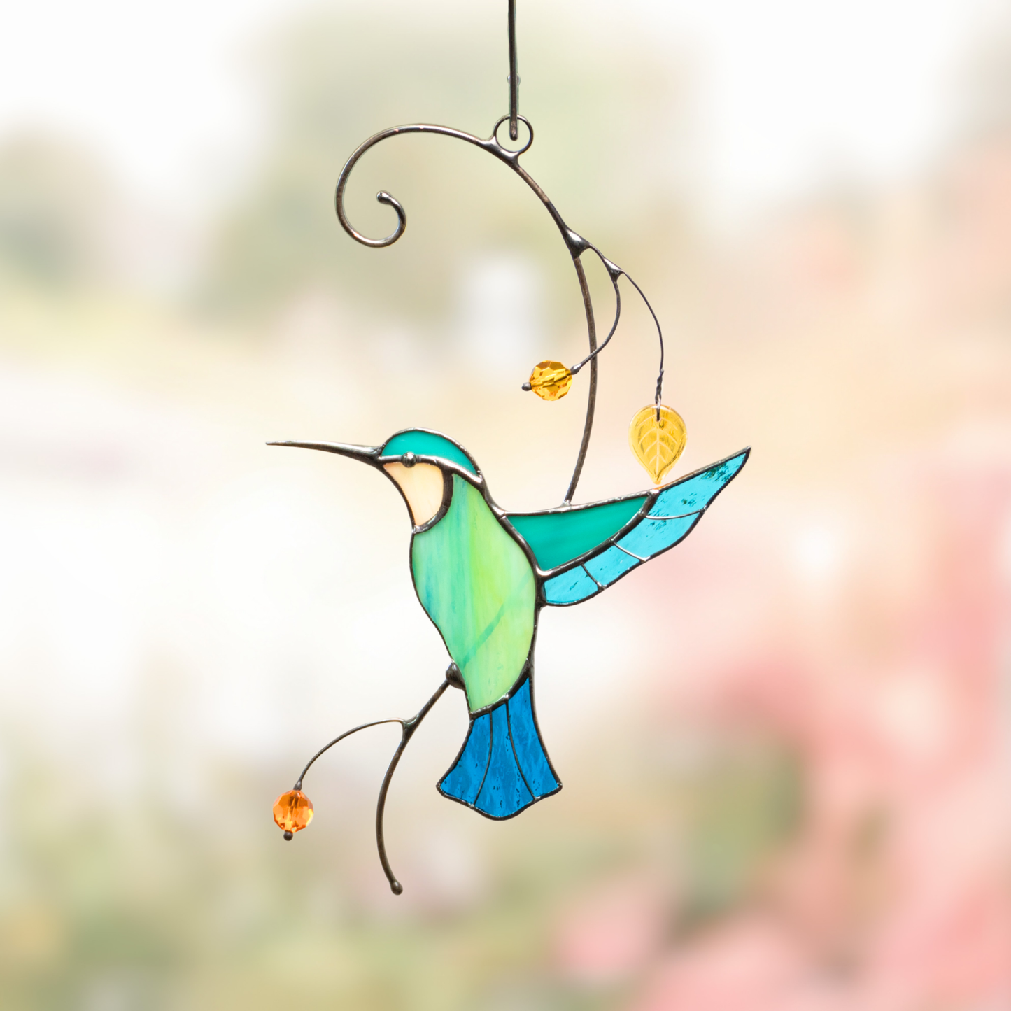 Turquoise hummingbird taking off the branch stained glass suncatcher